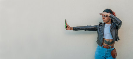 girl in the street looking at the mobile phone with a surprised expressionの写真素材