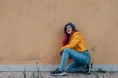 fashionable redhead urban girl on the street with copy-space