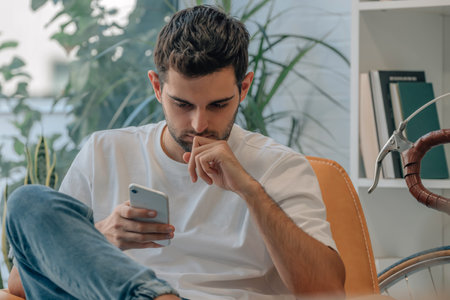 young man at home with mobile phone