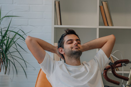man at home happily relaxing on the sofaの写真素材
