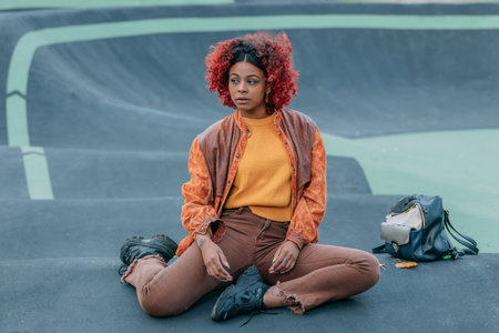 urban free-style hipster girl in the park sittingの写真素材