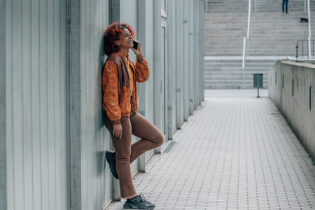 african american woman with mobile phone in the cityの写真素材