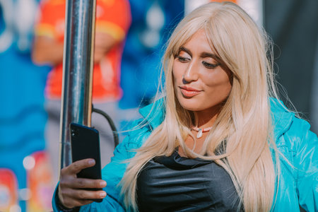 woman with mobile phone in amusement parkの写真素材