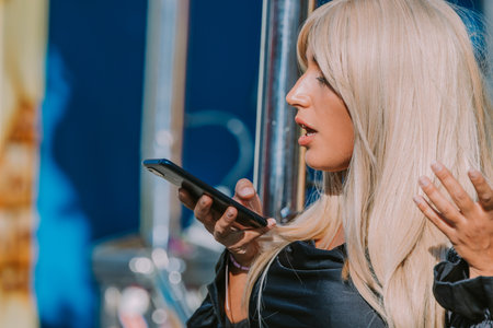 woman with mobile phone in amusement park