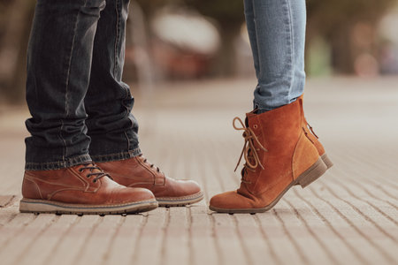 couple feet on the street in autumnの写真素材