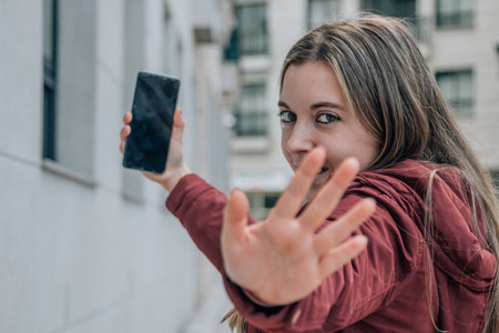 girl or student in the street with mobile phoneの写真素材