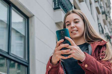 girl walking in the city talking on mobile phoneの写真素材