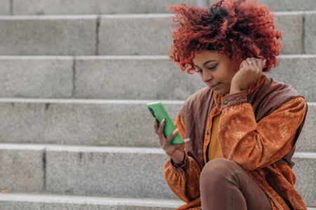 girl with mobile phone in the streetの写真素材