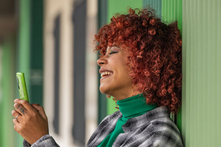 smiling girl looking at mobile phone or smartphoneの写真素材