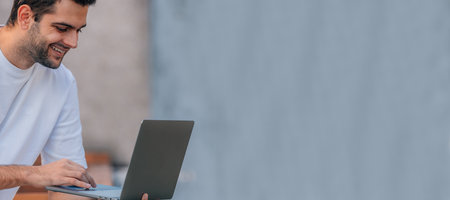 young man with laptop outdoorsの写真素材