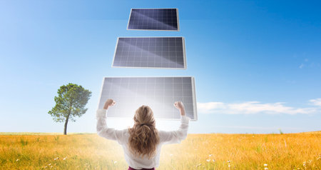 woman with successful expression with landscape with solar panels, environment and sustainabilityの写真素材