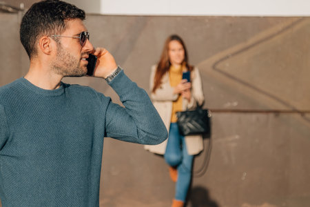 couple on the street with mobile phoneの写真素材