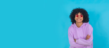 afro girl isolated on color background in sunglasses and purple pullover