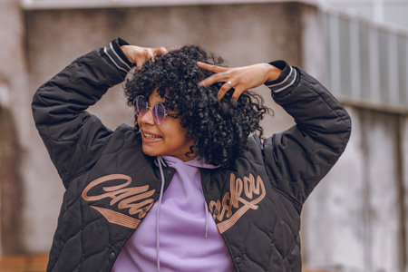 afro girl on the street happy with sunglassesの写真素材