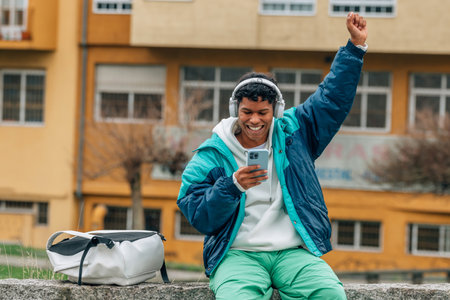 urban young man with headphones and phone listening to music in the streetの写真素材