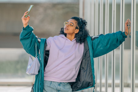 fashionable urban style girl with mobile phoneの写真素材