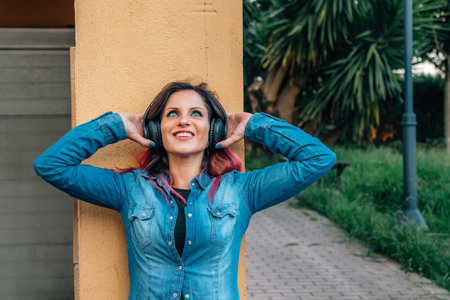 girl on the street with headphones listening to music