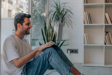 young man at home with laptopの写真素材