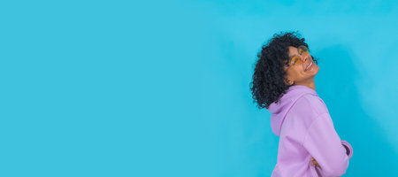portrait of smiling girl in sunglasses isolated on blue background