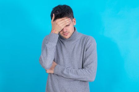 young man isolated on background with sorry expressionの写真素材