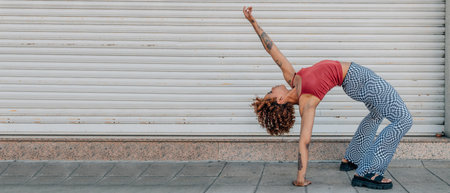 girl on the street dancing with acrobatic pose