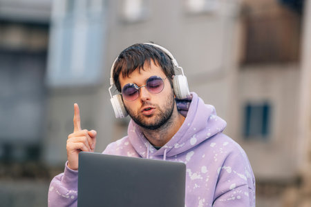 young man with headphones and laptop