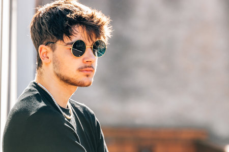 young male with sunglasses on the street