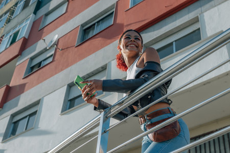 urban girl in the street with mobile phone and buildingの写真素材