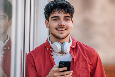 young man on the street with mobile phone or smartphoneの写真素材