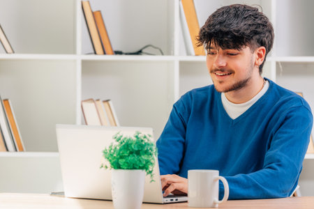 student at desk with computer or laptop