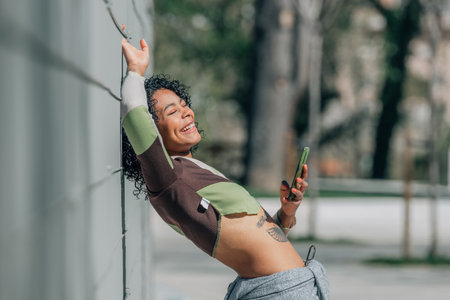 fashionable urban girl with mobile phone on the streetの写真素材