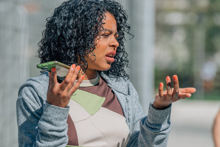 girl on the street arguing with mobile phoneの写真素材