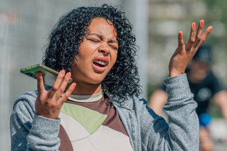 girl with mobile phone or smartphone in the streetの写真素材