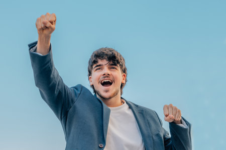 young male on the street with expression of success or celebrationの写真素材