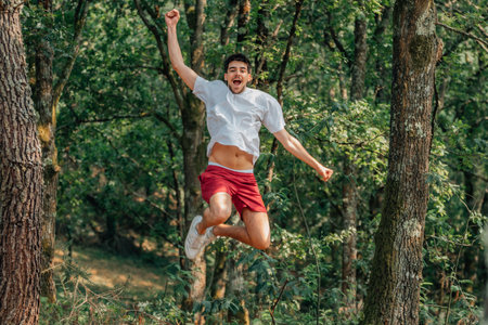 young sportsman jumping with enthusiasm outdoors