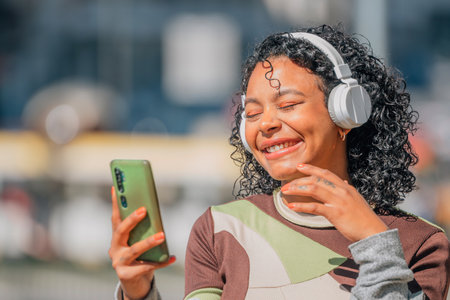 girl on the street with headphones and mobile phone