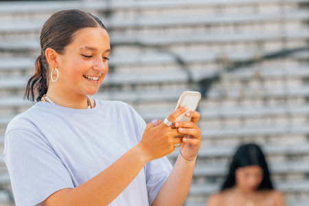 girl on the street looking at the mobile phone or smartphoneの写真素材