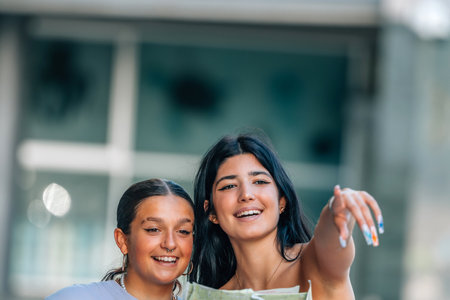 two travel girls on the street with a mapの写真素材