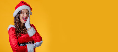 young woman wearing santa claus suit isolatedの写真素材