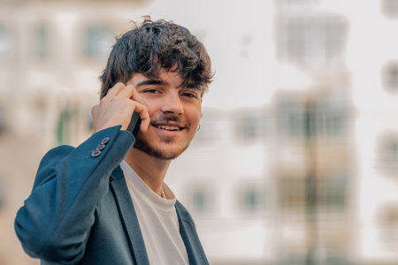 business man or university student with mobile phone on the streetの写真素材