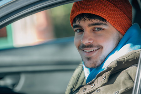 young man driving behind the wheel of the car