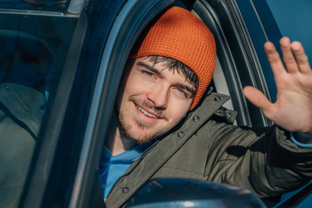 young man driving behind the wheel of the car