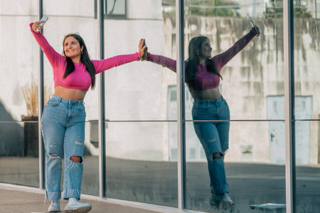 woman with mobile phone taking photo or recordingの写真素材