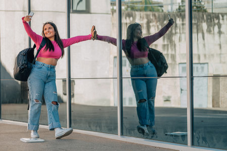 student with mobile phone on the street taking photo or recording