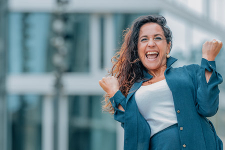 excited business woman celebrating successの写真素材