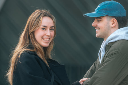 boy and girl couple on the street outdoors talking