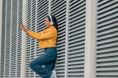 woman with headphones and mobile phone or smartphoneの写真素材