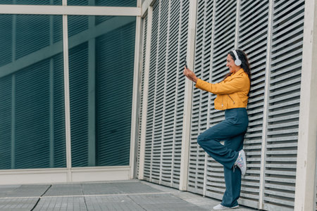 woman with headphones and mobile phone or smartphoneの写真素材