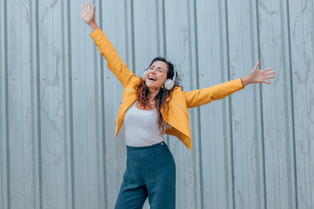 woman with headphones excited with joyの写真素材