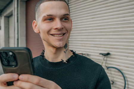 portrait young man on the street with smartphone or cell phone and bicycle